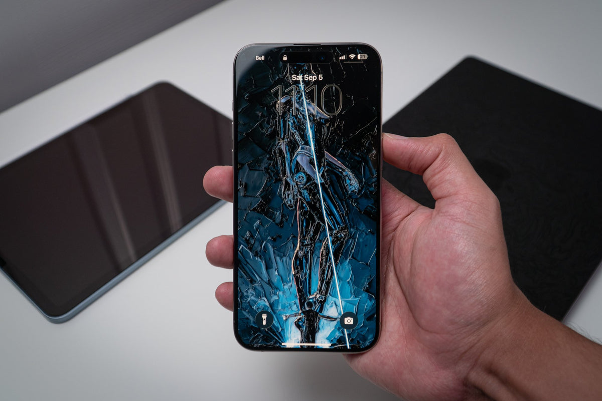 Shattered-glass blue archer figure, wallpaper on an iPhone lock screen